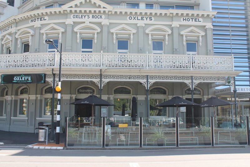 Street-facing historic Oxley's facade, veranda and outdoor seating on London Quay.